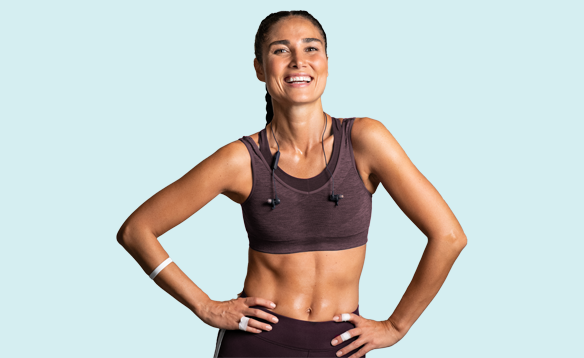 Young woman posing and smiling while wearting workout clothes | General Health & Wellness