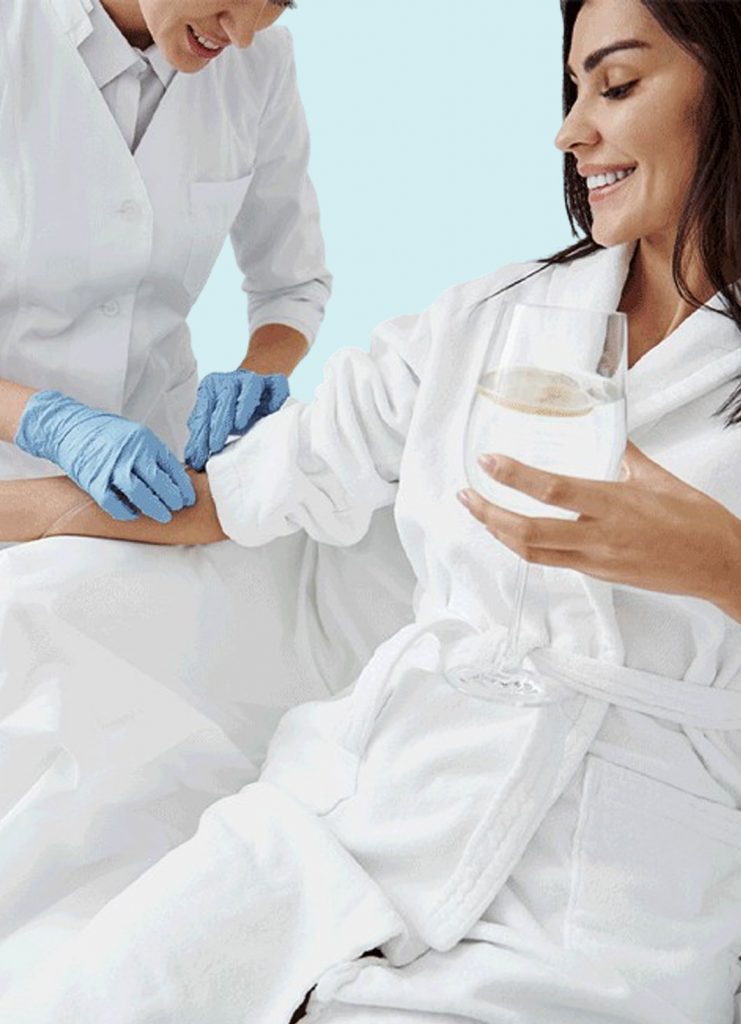 Woman wearing spa robe getting prepped for IV Therapy | IV Therapies